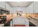 Well-lit kitchen featuring white cabinets, stainless steel appliances, and hardwood floors at 4601 Timbermill Ct # 302, Raleigh, NC 27612