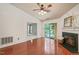 Bright living room with fireplace, ceiling fan, and sliding door to balcony at 4601 Timbermill Ct # 302, Raleigh, NC 27612