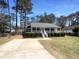 Charming single-story home featuring a welcoming front porch and well-maintained landscaping at 5605 Christie Ln, Durham, NC 27713