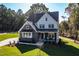 Beautiful two-story home with a stone and white facade and well-manicured lawn at 581 Magnolia Acres Ln, Fuquay Varina, NC 27526