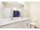 Modern bathroom featuring double sinks, white cabinets, and clean finishes at 609 Embrun Run, Wendell, NC 27591