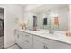 Elegant bathroom featuring double sinks, a large mirror, and modern fixtures at 609 Embrun Run, Wendell, NC 27591