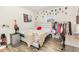 Bright bedroom with a white bed frame, mini fridge, and a closet/clothing rack feature at 609 Embrun Run, Wendell, NC 27591