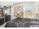 Stylish bedroom with a dark comforter, decorative wall hangings, and natural light at 609 Embrun Run, Wendell, NC 27591
