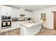 Well-lit kitchen featuring white cabinets, stainless steel appliances, and a central island at 609 Embrun Run, Wendell, NC 27591
