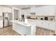 Bright kitchen features a large island with granite countertops and stainless steel appliances at 609 Embrun Run, Wendell, NC 27591