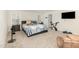 Bright main bedroom with carpeted floors, a comfortable bed, and exercise equipment at 609 Embrun Run, Wendell, NC 27591
