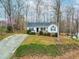Charming one-story home with a well-manicured lawn, inviting front porch and long driveway at 6208 Silver Spring Ct, Willow Springs, NC 27592