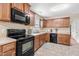 Well-lit kitchen features wooden cabinets, modern appliances and neutral countertops at 6208 Silver Spring Ct, Willow Springs, NC 27592