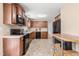 Well-equipped kitchen offers ample counter space, wooden cabinets, and black appliances at 6208 Silver Spring Ct, Willow Springs, NC 27592