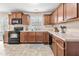 Functional kitchen with wooden cabinets, modern appliances, and ample countertop space at 6208 Silver Spring Ct, Willow Springs, NC 27592
