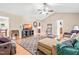 A cozy living room with wood floors, a ceiling fan, comfortable couches, and an inviting atmosphere at 6208 Silver Spring Ct, Willow Springs, NC 27592