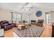 Inviting living room featuring vaulted ceiling, stylish rug, comfortable seating, and a decorative clock at 6208 Silver Spring Ct, Willow Springs, NC 27592
