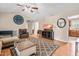 Well-lit living room showcasing wood floors, vaulted ceiling, comfortable seating, and modern entertainment center at 6208 Silver Spring Ct, Willow Springs, NC 27592