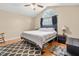 A bedroom featuring high ceilings, a comfortable bed, a rug, and a large window at 6208 Silver Spring Ct, Willow Springs, NC 27592