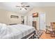 Bright bedroom showcasing a comfortable bed, hardwood floors, and a cozy rocking chair at 6208 Silver Spring Ct, Willow Springs, NC 27592