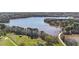 Aerial shot of a lakefront house, with trees, a dock, and open field with a red barn at 749 Hadrian Dr, Garner, NC 27529