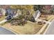 Beautiful house showcasing meticulous landscaping with mature trees and shrubs on a sunny day at 749 Hadrian Dr, Garner, NC 27529