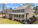 Aerial view of the backyard featuring a covered porch, manicured lawn, and black aluminum fence at 749 Hadrian Dr, Garner, NC 27529