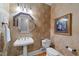 Elegant powder room with pedestal sink, decorative mirror, and wallpaper at 749 Hadrian Dr, Garner, NC 27529