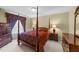 This bedroom features a four-poster bed, wood furnishings, and a traditional aesthetic at 749 Hadrian Dr, Garner, NC 27529