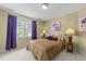 Cozy bedroom with a comfortable bed, bedside lamps, and a bright window view at 749 Hadrian Dr, Garner, NC 27529
