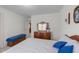 Bright bedroom featuring a wooden dresser with mirror and a blue accented bed at 749 Hadrian Dr, Garner, NC 27529