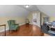 Cozy attic bonus room with a workspace and a comfortable green chair at 749 Hadrian Dr, Garner, NC 27529