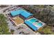 Aerial shot of community pool area with pool, parking, and blue metal roof building at 749 Hadrian Dr, Garner, NC 27529