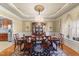 Formal dining room with elegant chandelier, dining table, and decorative moldings at 749 Hadrian Dr, Garner, NC 27529