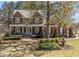 Beautiful two-story brick home with mature landscaping and a charming front yard fountain at 749 Hadrian Dr, Garner, NC 27529