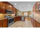 Modern kitchen with stainless steel appliances, granite countertops, and tile flooring at 749 Hadrian Dr, Garner, NC 27529
