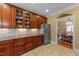 Spacious kitchen with custom wood cabinets, stainless steel fridge and view to formal dining area at 749 Hadrian Dr, Garner, NC 27529