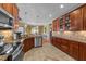 Well-equipped kitchen with wooden cabinetry, tile backsplash, and modern appliances at 749 Hadrian Dr, Garner, NC 27529