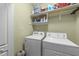 Functional laundry room with appliances and storage shelving at 749 Hadrian Dr, Garner, NC 27529