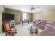 Spacious living room with plush seating, glass coffee table, and large TV at 749 Hadrian Dr, Garner, NC 27529