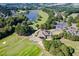 Aerial view showcasing a beautiful golf course community, clubhouse, and surrounding natural landscape at 904 Hidden Jewel Ln, Wake Forest, NC 27587