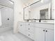 Modern bathroom features a dual-sink vanity with sleek white cabinets and a shower/tub combination at 904 Hidden Jewel Ln, Wake Forest, NC 27587
