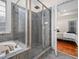 Modern bathroom featuring walk-in shower and luxurious soaking tub at 904 Hidden Jewel Ln, Wake Forest, NC 27587