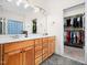 Traditional bathroom featuring double sinks, closet access, and natural light at 904 Hidden Jewel Ln, Wake Forest, NC 27587