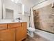 Well-lit bathroom features a tiled shower with grab bars and a spacious vanity area at 904 Hidden Jewel Ln, Wake Forest, NC 27587