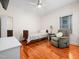Cozy bedroom featuring hardwood floors, a ceiling fan, and a comfy recliner at 904 Hidden Jewel Ln, Wake Forest, NC 27587