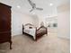 Cozy bedroom featuring soft carpeting, a ceiling fan, and a beautiful wood bed frame at 904 Hidden Jewel Ln, Wake Forest, NC 27587