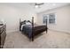 Bright bedroom features soft carpeting, a ceiling fan, and a beautiful four-poster bed at 904 Hidden Jewel Ln, Wake Forest, NC 27587