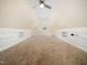 Spacious bonus room featuring built-in shelving and soft carpeting at 904 Hidden Jewel Ln, Wake Forest, NC 27587