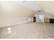 Large bonus room with a ceiling fan, built-in shelving, and a convenient wet bar at 904 Hidden Jewel Ln, Wake Forest, NC 27587