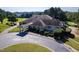 Aerial shot of a clubhouse, with a circular drive, landscaped grounds, and views of the golf course at 904 Hidden Jewel Ln, Wake Forest, NC 27587