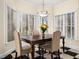 Bright dining room featuring checkerboard flooring, large windows, and a chandelier at 904 Hidden Jewel Ln, Wake Forest, NC 27587