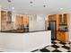 Well-lit kitchen with wooden cabinets, stainless steel appliances, and a black-and-white tiled floor at 904 Hidden Jewel Ln, Wake Forest, NC 27587