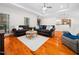 Cozy living room featuring hardwood floors, ample seating, and a view to kitchen at 904 Hidden Jewel Ln, Wake Forest, NC 27587